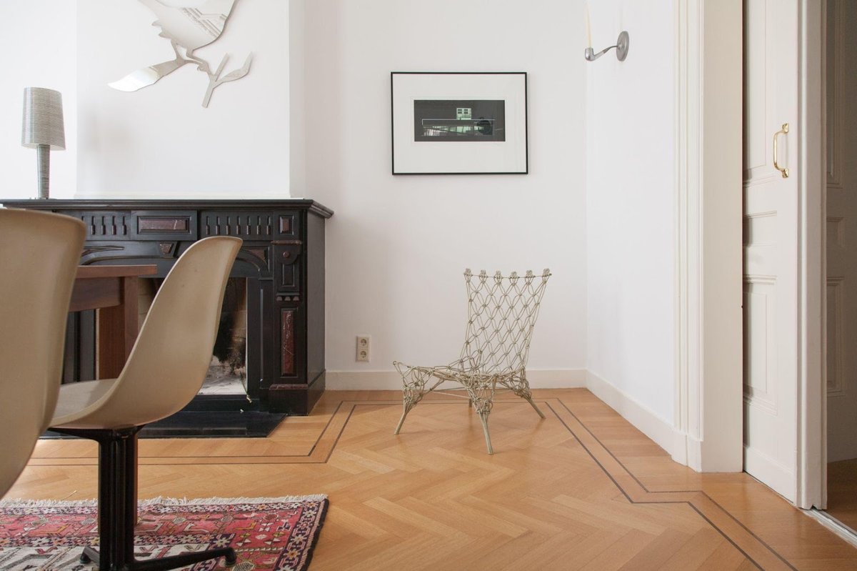 A Hall Room with a Fancy Chair and Laminate Flooring